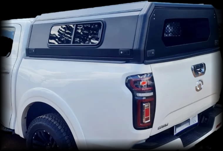 Black canopy fitted to a white double cab pickup